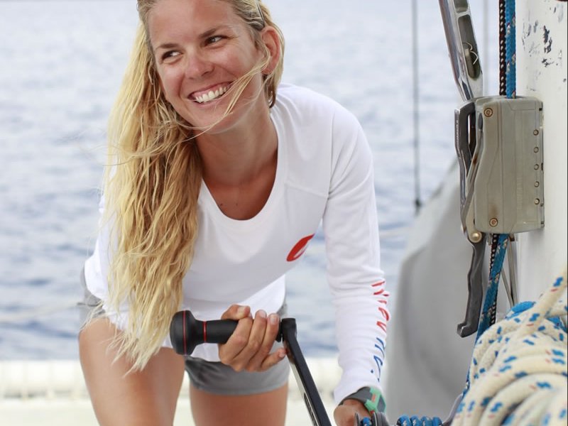 a woman riding on the back of a boat