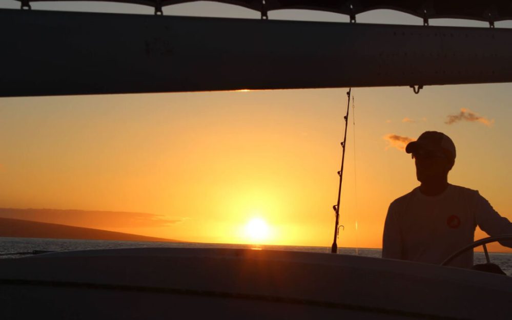 a man standing in front of a sunset