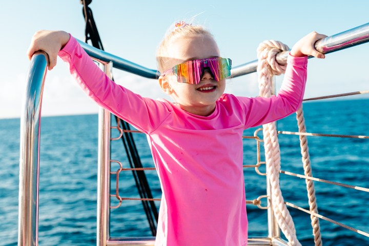 a woman standing next to a body of water