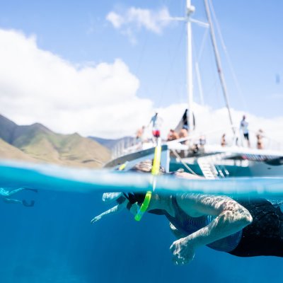 a person flying through the air while riding a wave in the ocean