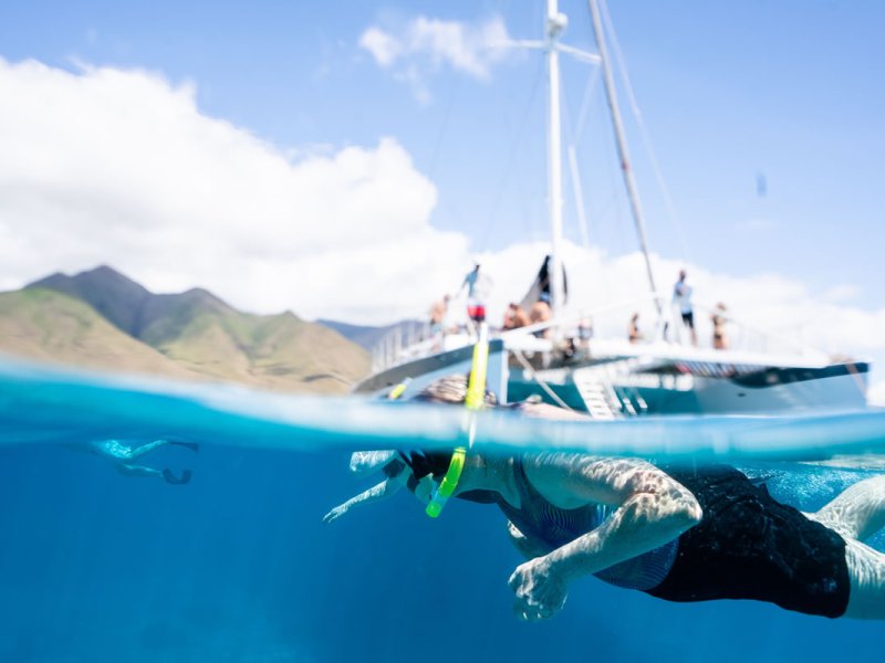 a person flying through the air while riding a wave in the ocean