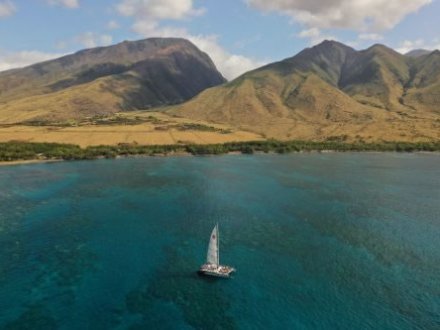 a body of water with a mountain in the background