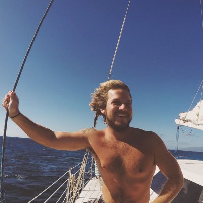 a man standing next to a body of water