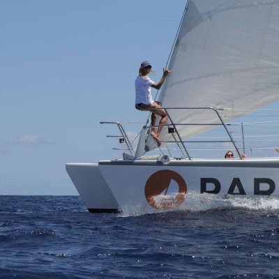 a man riding on the back of a boat in the water