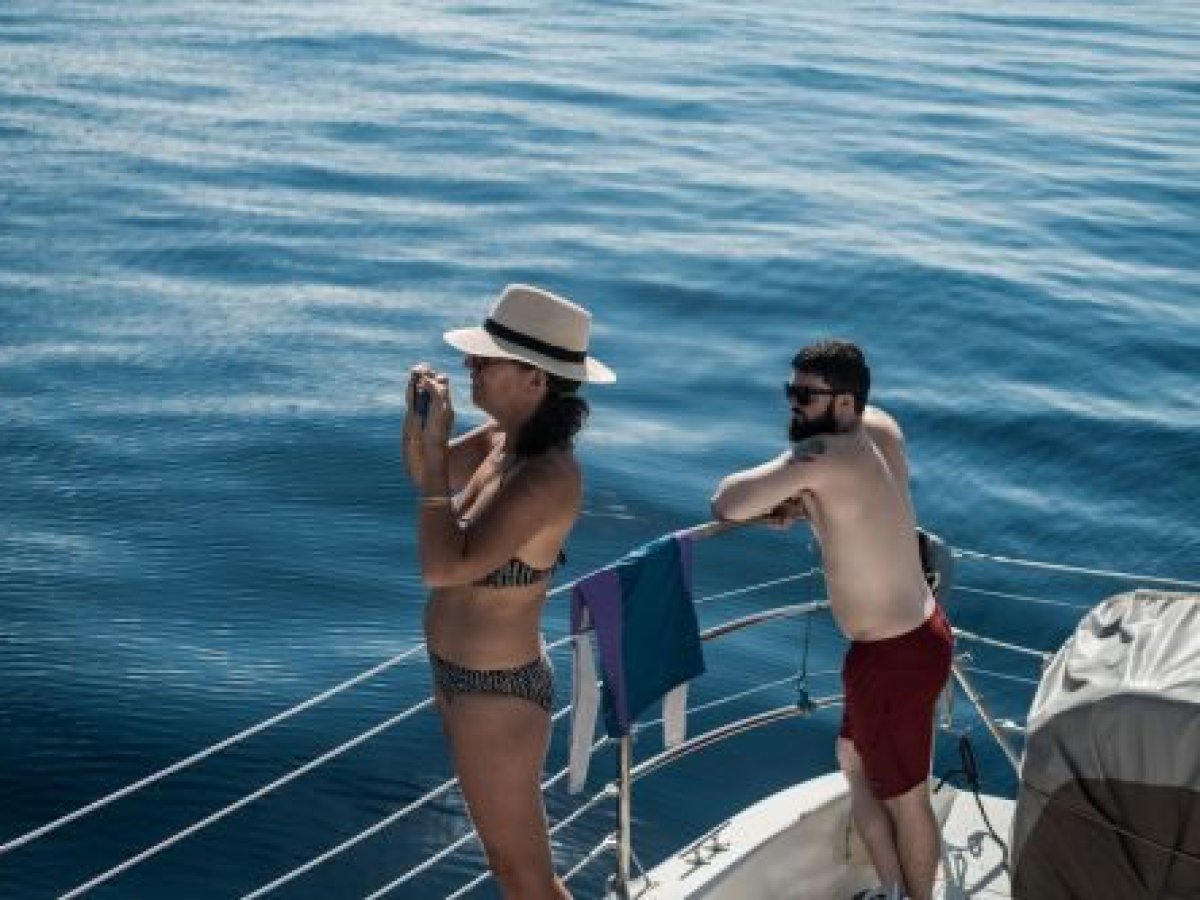 a woman standing next to a body of water