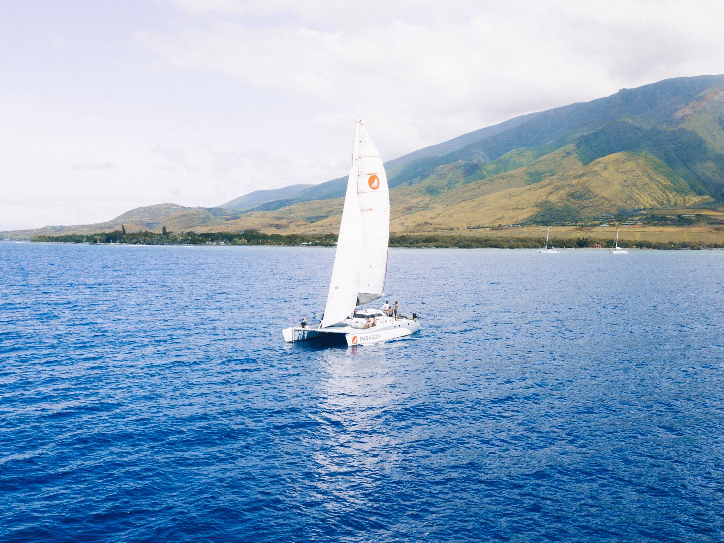 a small boat in a body of water with a mountain in the background