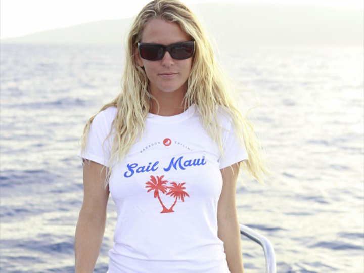 a woman standing next to a body of water