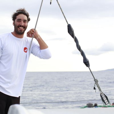 a man standing next to a body of water