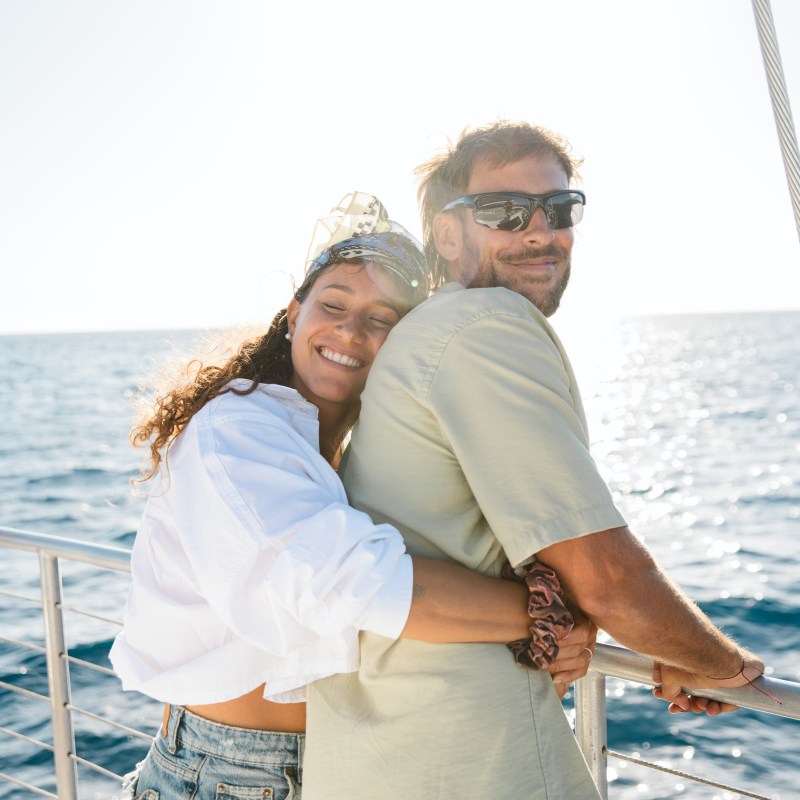 a man and a woman standing next to a body of water