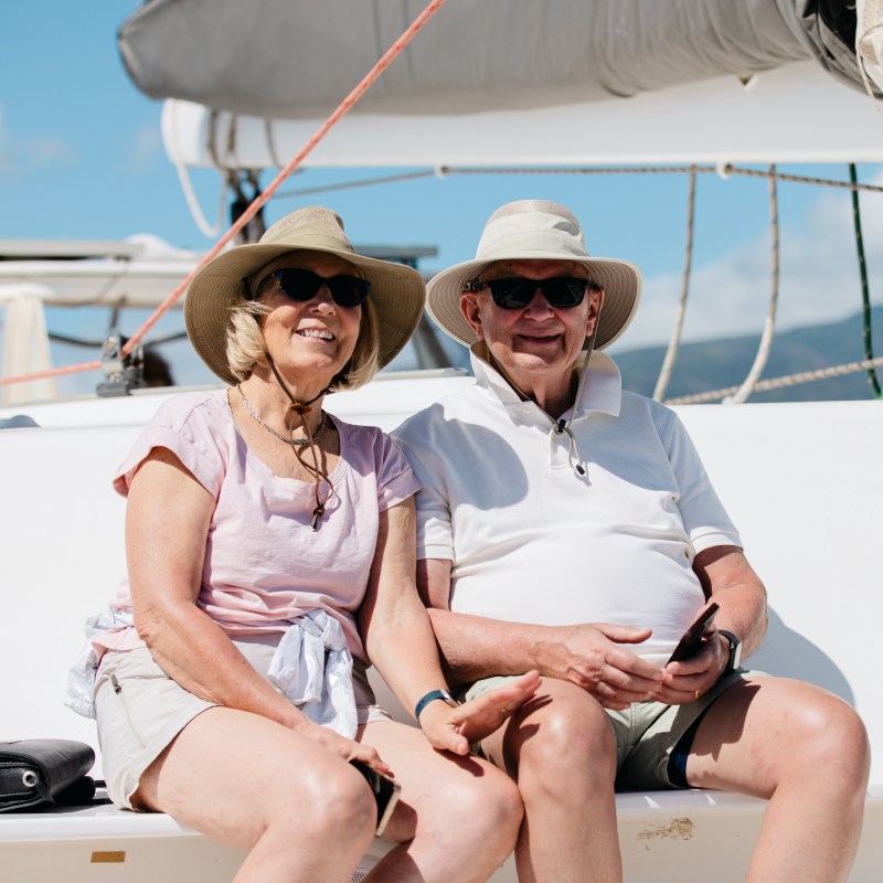 a man and a woman sitting on a boat