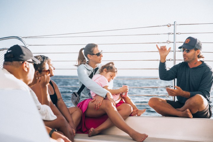 a group of people sitting at a beach