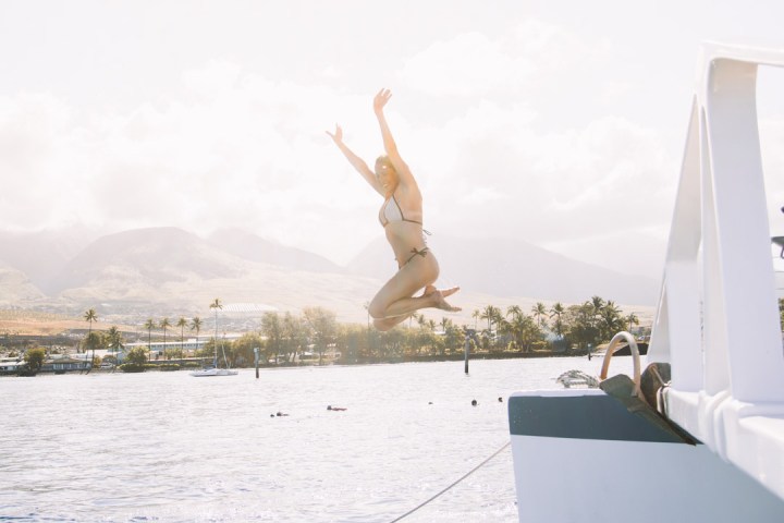 a person standing next to a body of water